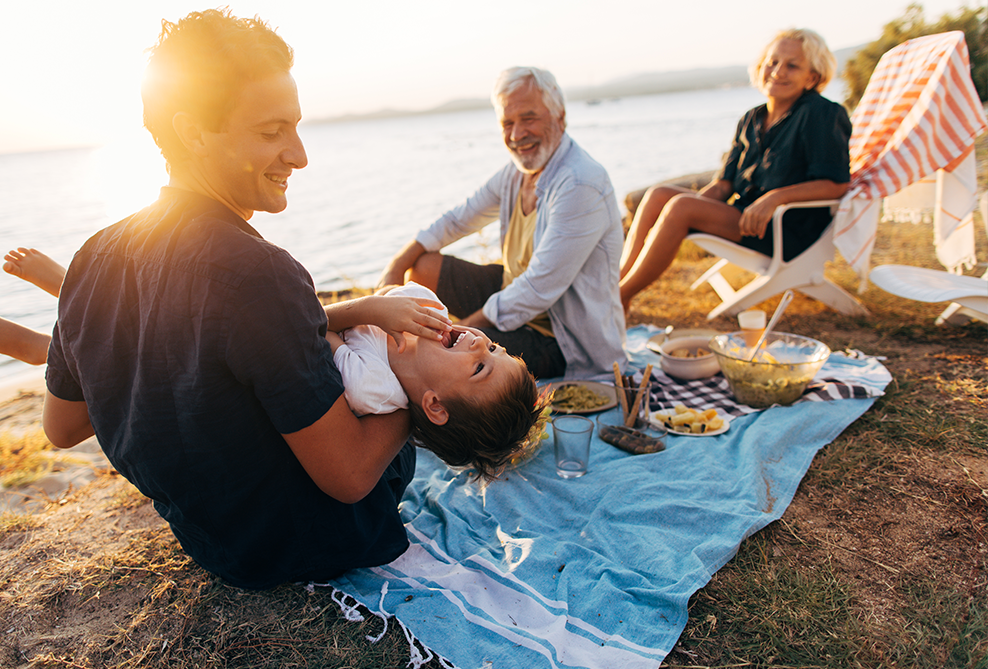 family on a picnic next to the water